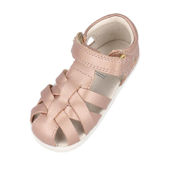 The Bobux Step Up Tropicana II Rose Gold Sandal 732318 Quick Dry is a toddler sandal with a closed toe, woven quick dry leather straps, and a hook-and-loop ankle strap, shown in light pink on a white background., 9420075778528, 9420075772502, 9420075772175, 9420075772731