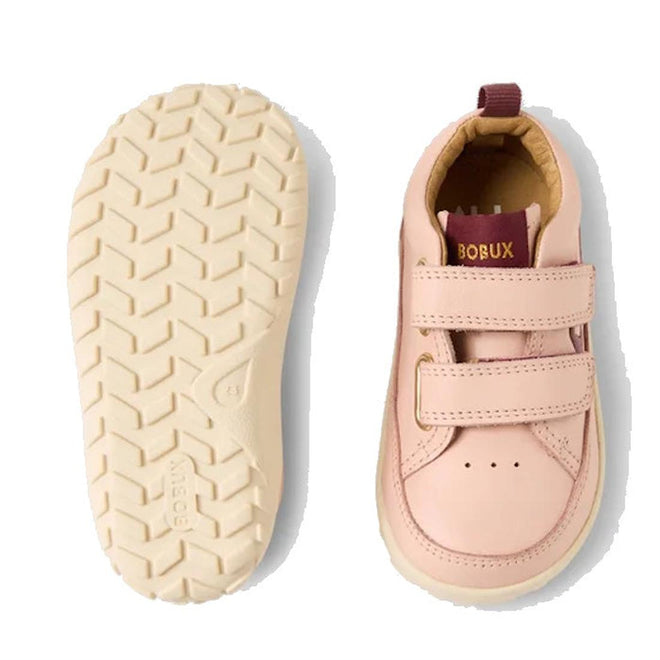 The Bobux SU Step Up Dawn Leather Boot in Cameo Rose Pink Alpha is a pair of pink barefoot shoes for first walkers, featuring two velcro straps, chevron-patterned cream-colored soles, and a maroon and gold BOBUX label on the tongue., 9420068578821, 9420068578838, 9420068578845