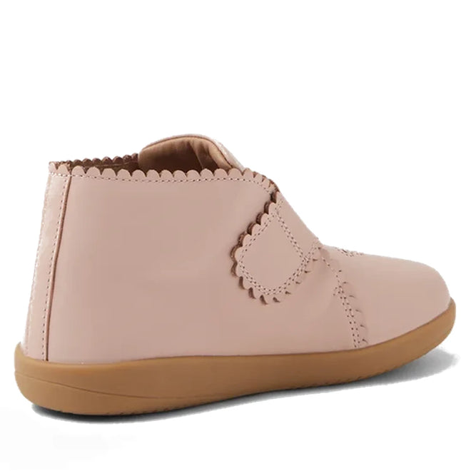 The Bobux Step Up Willow First Walker Boot in Cameo Rose Pink features light pink leather, a tan rubber sole, scalloped edges, and an adjustable Velcro strap—ideal for toddlers taking their first steps., 51154, 9420068544833, 9420068544840, 9420068544857