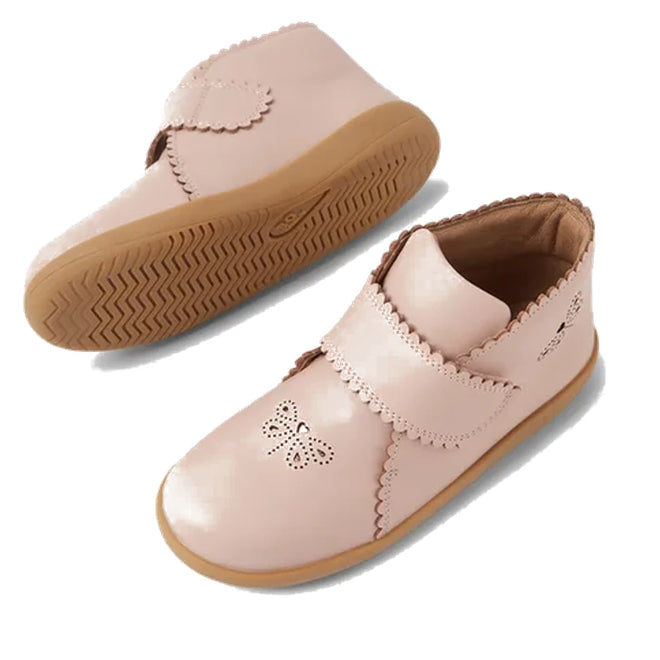 The Bobux Step Up Willow First Walker Boot in Cameo Rose Pink features light pink leather, scalloped edges, a butterfly cutout on the toe, and an adjustable hook-and-loop strap—perfect for toddlers. Shown on a white background., 51154, 9420068544833, 9420068544840, 9420068544857