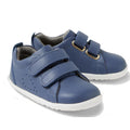 The Bobux Step Up Grass Court Trainer Vintage Indigo Blue Shoes are toddler sneakers with white soles and two hook-and-loop straps, shown on a white background—perfect for first walkers.