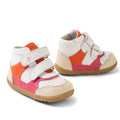 A pair of Bobux SU Harley First Walker Leather Boots in bright pink, featuring white, orange, pink, and beige panels with Velcro straps and brown rubber soles, shown on a white background.