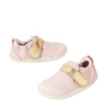 The Bobux XP Xplorer First Walking Shoes Go Ballet Pink are soft pre-walker leather shoes with white soles and shiny gold Velcro straps, featuring a flexible sole for baby's first steps, shown on a white background.
