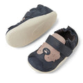 Two Bobux XP Xplorer Howl First Walking Shoes in navy feature soft beige soles, a bear face on the toe, and an adjustable Velcro strap. One pre walker shoe faces up; the other displays its sole., 9420074806000, 9420074806017, 9420074806024, 9420074806031, 9420074805997, 9420074806000, 9420074806017, 9420074806024, 9420074806031