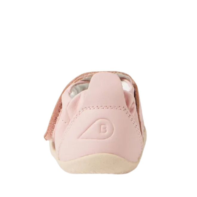 A rear view of the Bobux Explorer Marvel Ballet Pink Dress Shoe First Walker, featuring pink leather, a light beige sole, and a subtle embossed heel logo, ideal as pre-walker shoes, shown against a white background.