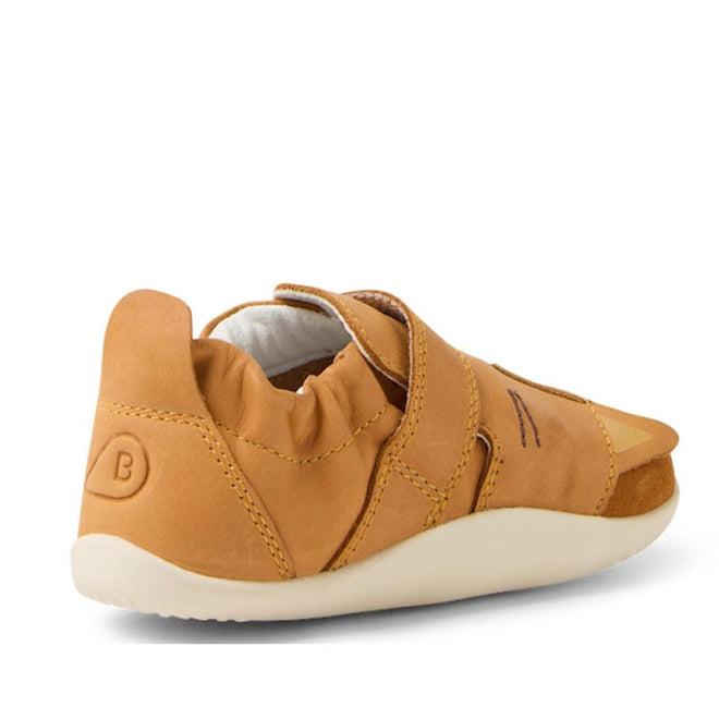 The Bobux XP Xplorer Rummage First Walking Shoes in Pumpkin Spice Orange feature a flexible EVA sole, elasticized heel, and velcro strap, shown angled from the back—perfect pre-walker shoes for toddlers., 9420074805904, 9420074805911, 9420074805928, 9420074805935