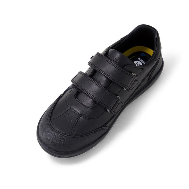 The Bobux Kid+ Black School Leather Shoe Traverse Trainer is a single black leather sneaker with two Velcro straps, a rounded toe, and cushioned insole. The durable kids’ shoe is angled on a white background., 9420075762978, 9420075762985, 9420075762992, 9420075763005, 9420075763012, 9420075763029, 9420075763036