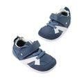 Introducing the Bobux Xplorer XP Chase Vintage Indigo Blue First Walker Crawler: a stylish pair of baby sneakers in blue and white, featuring both velcro straps and laces—perfect for your little one’s first steps, elegantly displayed on a white background.