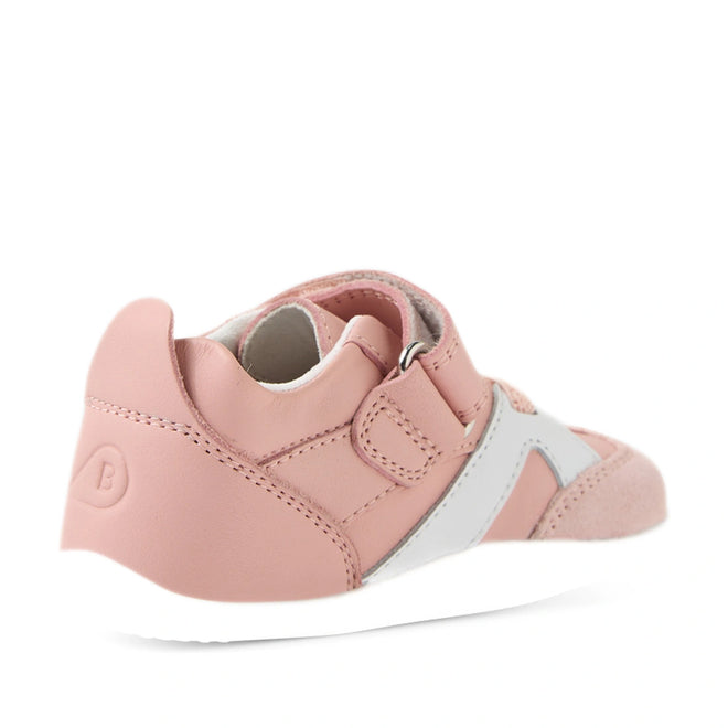 A Ballet Pink and white Bobux Xplorer XP Chase sneaker with a Velcro strap, shown from the back left side, featuring a textured sole and the letter B embossed on the heel—ideal as first walker crawler shoes for little ones., 9420074850683, 9420074850690, 9420074850706, 9420074850713