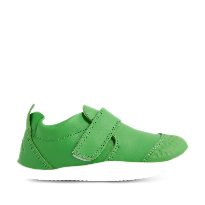 Shown against a white background is the Bobux Xplorer XP Go Retro Green First Walker Crawler—a green baby shoe featuring a Velcro strap and white sole. Crafted from flexible leather, these shoes are perfect for first walkers, providing gentle support for little feet., 9420074808981, 9420074808998, 9420074809001