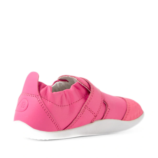 The Bobux Xplorer XP Go Pink Lemonade First Walker Crawler is featured angled backward on a white background, showcasing its pink leather design with a white sole, elastic heel, and velcro strap—perfect as toddler shoes or soft first walker footwear for little ones taking their first steps., 9420074809032, 9420074809049, 9420074809056