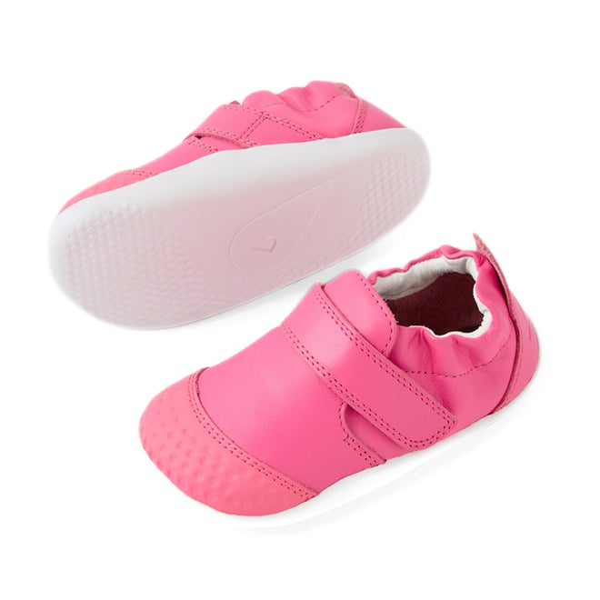 Two Bobux Xplorer XP Go Pink Lemonade First Walker Crawler shoes are shown, one upright and one on its side. These adorable pink baby shoes feature a Velcro strap, elastic around the ankle, and textured toe and sole areas for added stability., 9420074809032, 9420074809049, 9420074809056