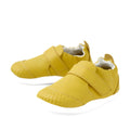 The Bobux Xplorer XP Go Mango Mint First Walker Crawler is a pair of yellow toddler walking shoes featuring hook-and-loop straps, textured toe areas, and white soles. Crafted from soft leather, these shoes are perfect as first walker footwear and are displayed on a white background.