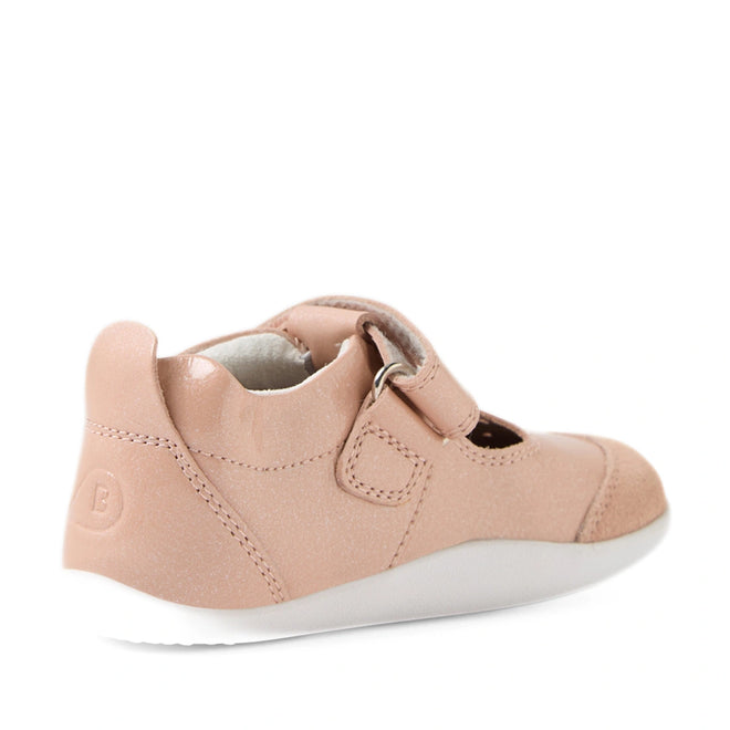 The Bobux XP Explorer Rue First Walker Sandal in Camo Rose Pink is a children’s shoe featuring a pink upper, hook-and-loop strap, and white sole. Seen from the back-left angle, this flexible sole toddler shoe has a rounded heel and soft design—ideal for little feet on the move., 9420074851246, 9420074851253, 9420074851260