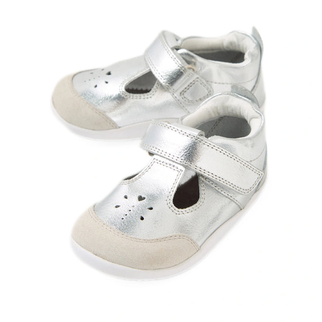 Your rewritten sentence using the product data: The Bobux XP Explorer Rue First Walker Sandal in Silver features a pair of shiny silver baby shoes with beige toe caps, white soles, and easy Velcro straps—perfect as first walking shoes. Heart-shaped cutouts decorate the tops of these stylish pre-walker sandals., 9420074851192, 9420074851208, 9420074851215