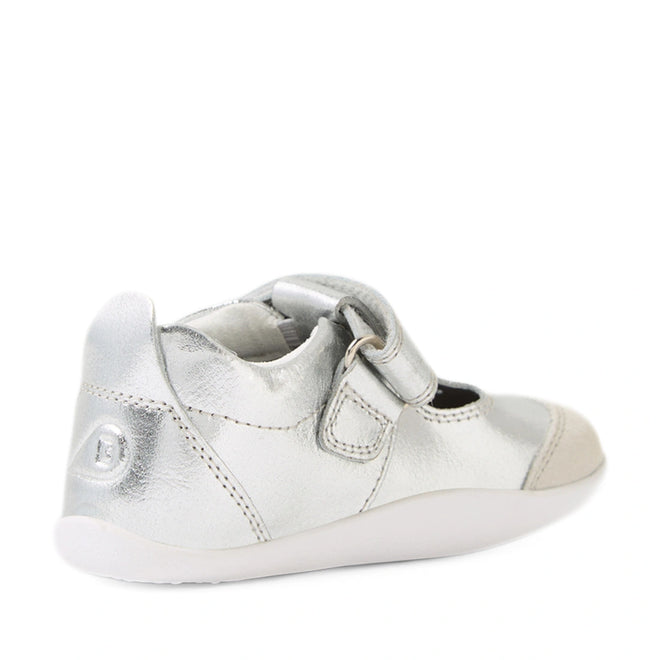 The Bobux XP Explorer Rue First Walker Sandal in silver, featuring a white sole, velcro strap, and reinforced toe—perfect as first walking or pre-walker shoes—is shown from the back against a white background., 9420074851192, 9420074851208, 9420074851215
