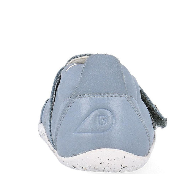 A close-up of the Bobux XP Explorer Beau First Walker Sandal 502303 shows its light blue color, flexible sole, white speckled detail, B logo on the heel, and soft stitched material—ideal for toddlers learning to walk., 9420075784628, 9420075784994, 9420075783652, 9420075783188
