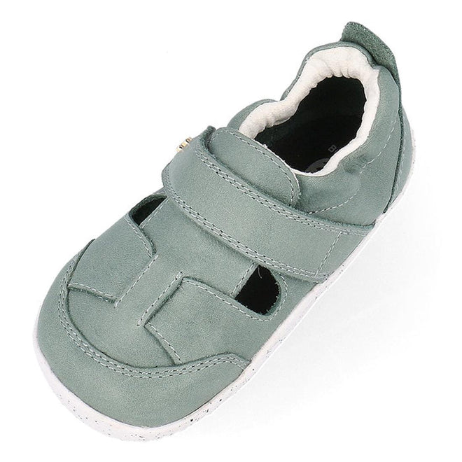 The Bobux XP Explorer Beau First Walker Sandal Sage Green 502304 is a light green toddler shoe with a closed toe, white flexible sole, and a hook-and-loop strap for comfort and easy fastening for early walkers., 9420075784499, 9420075783676, 9420075783706, 9420075784208