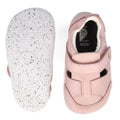 The Bobux XP Explorer Beau First Walker Sandal in Blossom Pink features white, textured flexible soles with black speckles. One shoe is shown from the top with a velcro strap; the other displays its sole., 9420075785915, 9420075784284, 9420075783980, 9420075784635