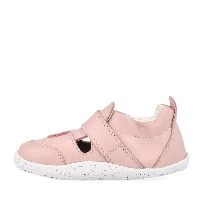 The Bobux XP Explorer Beau First Walker Sandal in Blossom Pink 502305 features cut-out sides, a Velcro strap, a light pink upper, white speckled flexible sole, and a heel pull tab; shown side view on a white background., 9420075785915, 9420075784284, 9420075783980, 9420075784635
