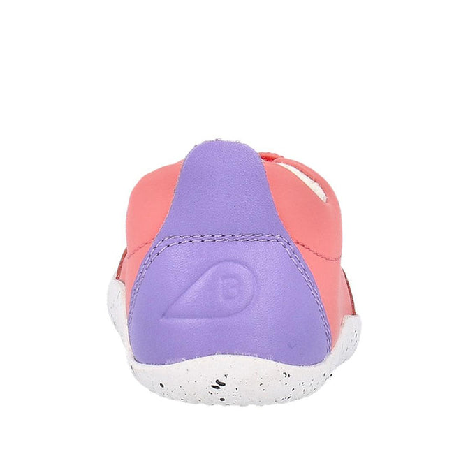 The Bobux XP Explorer Sport First Walker Sneaker Ocean Coral 502204, shown from the back, features a pink upper, purple heel with embossed logo, and a white speckled flexible sole against a plain white background., 9420075785427, 9420075783324, 9420075784512, 9420075783621