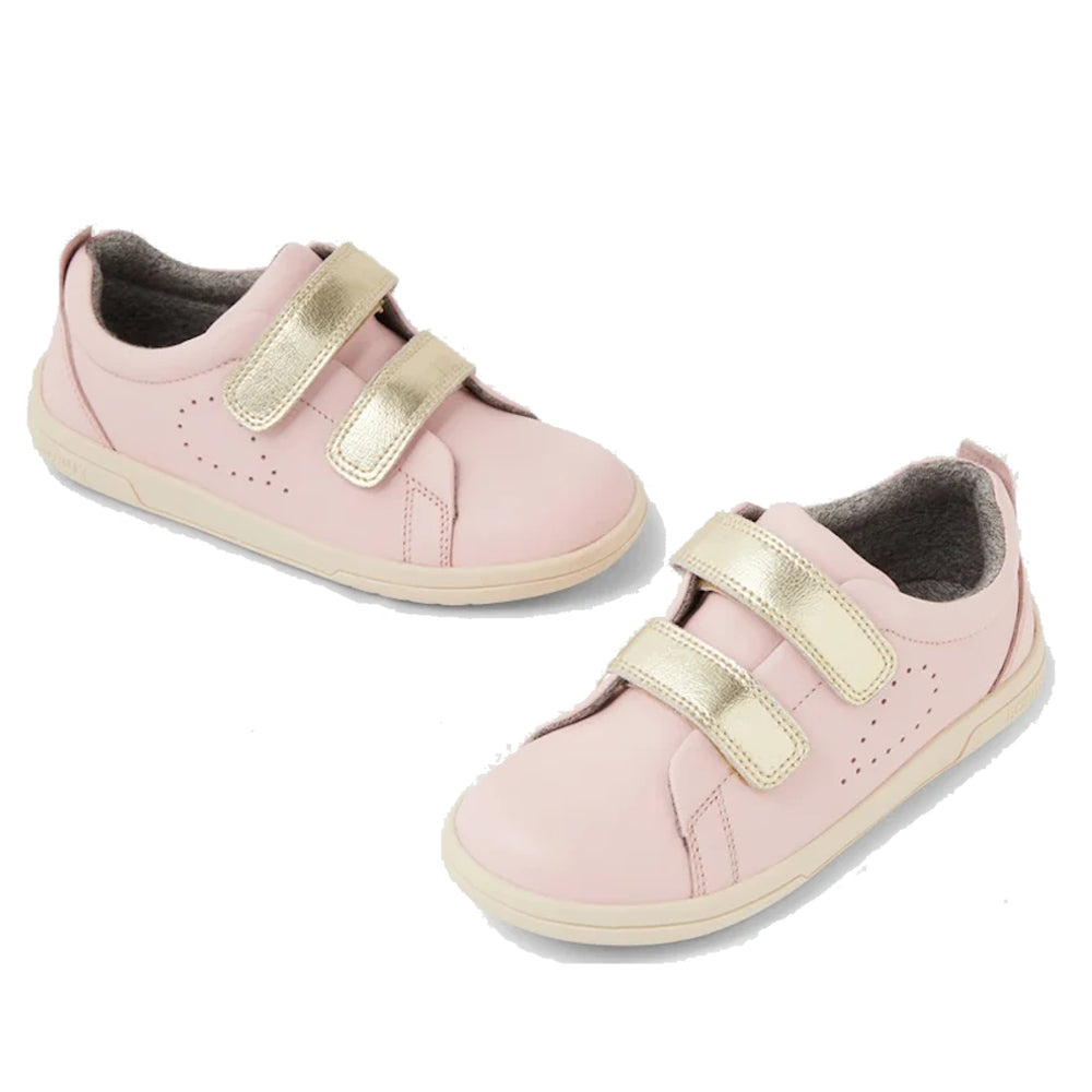 The Bobux KP Kid Plus Grass Court Ballet Pink 841018 are premium leather kids' shoes in light pink, featuring a street-style trainer design with gold Velcro straps, white soles, and soft gray lining, displayed on a white background.