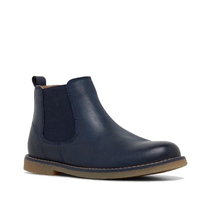 The Clarks Kids Chelsea II Youths Leather Boot in navy leather features elastic side panels and a light brown rubber sole, shown on a white background.