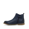 The Clarks Kids Chelsea II Youths Leather Boot in navy leather features a side zipper, back pull tab, decorative strap, and light brown flat sole, shown on a white background., 9336078964427, 9336078964434, 9336078964441, 9336078964458, 9336078964465, 9336078964472, 9336078964489, 9336078964496, 9336078964502, 9336078964519, 44021, 44022