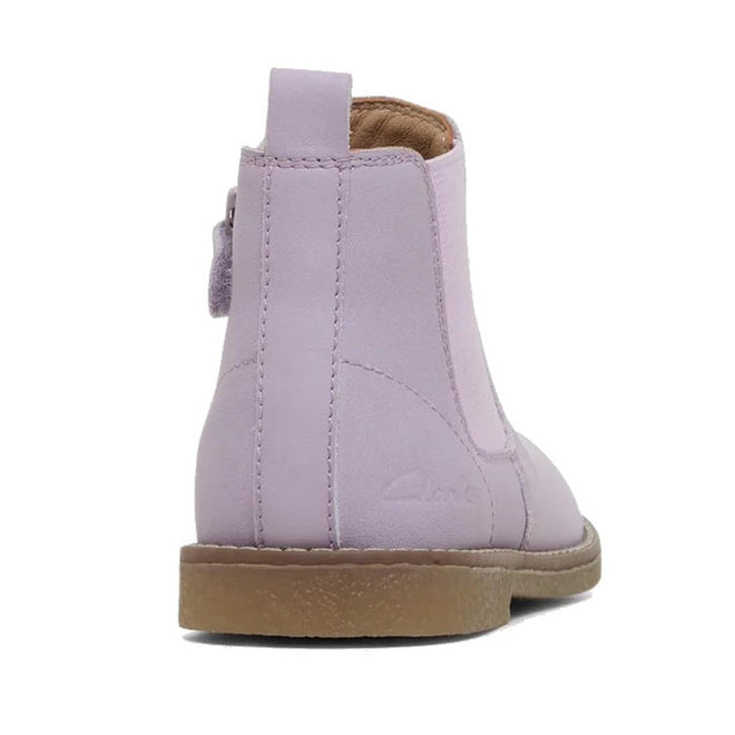 The Clarks Kids Chelsea II Youths Leather Boot in lilac features genuine leather, a tan rubber sole, visible stitching, a heel pull tab, and classic Chelsea styling. Shown from the back right side., 9336078964304, 9336078964311, 9336078964328, 9336078964335, 9336078964342, 9336078964359, 9336078964366, 9336078964373, 9336078964380, 9336078964397, 9336078964403, 9336078964410