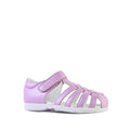 The Clarks Shelly Lilac Toddlers Leather Closed Toe Sandal features a pink design with multiple straps, a white sole, a side Velcro closure, and premium leather construction, shown against a plain white background.