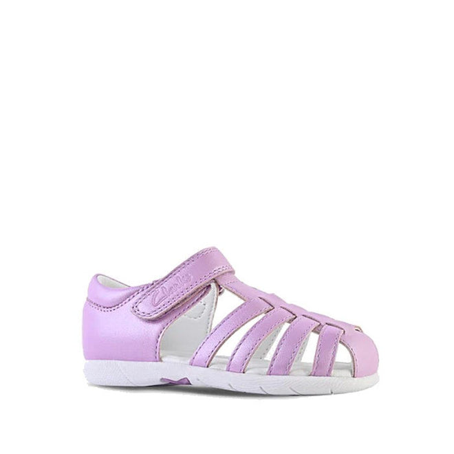 The Clarks Shelly Lilac Toddlers Leather Closed Toe Sandal features a pink design with multiple straps, a white sole, a side Velcro closure, and premium leather construction, shown against a plain white background.