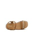 The Clarks Girls Amy Tan Leather Sandal Special Occasion features an adjustable ankle strap and a bold gold chain across the toe. Displayed on a white background, these stylish leather sandals are perfect for any fashionable girl., 40498, 40499, 40500, 40501, 40502, 40503, 9336078207838, 9336078207852, 9336078207876, 9336078207890, 9336078207913, 9336078207937, 9336078207951, 9336078207975, 9336078207999, 9336078208019, 40514, 40515