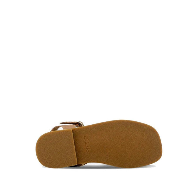 The Clarks Girls Amy Tan Leather Sandal Special Occasion is shown from the bottom, revealing a flat, textured sole with minimal tread and the Clarks brand name embossed near the heel., 40498, 40499, 40500, 40501, 40502, 40503, 9336078207838, 9336078207852, 9336078207876, 9336078207890, 9336078207913, 9336078207937, 9336078207951, 9336078207975, 9336078207999, 9336078208019, 40514, 40515