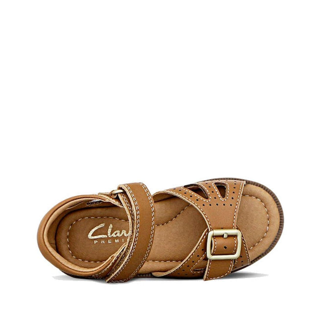 The Clarks Carrie Tan Leather Girls Sandal, shown from above on a white background, features a single brown sandal with cushioned insole, ankle strap, side buckle, and decorative stitching—perfect for everyday wear., 9336078210852, 9336078210890, 9336078210937, 9336078210975, 9336078211019, 39903, 39905, 39908, 39909, 39911, 39912, 39913
