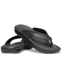 A pair of Crocs - Mens In Motion Flip Flop Jandal Black Grey with textured footbeds and perforated straps featuring LiteRide foam comfort, displayed one atop the other on a white background.