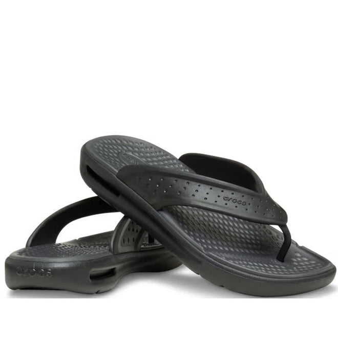 A pair of Crocs - Mens In Motion Flip Flop Jandal Black Grey with textured footbeds and perforated straps featuring LiteRide foam comfort, displayed one atop the other on a white background.