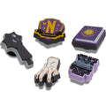 The Crocs Jibbitz 5 Pack - Adams Family includes five charms shaped like a cello, hand, shield, book, and typewriter in purple, black, yellow, and gray—perfect for Wednesday fans or collectors at a special discount!., 196265727964
