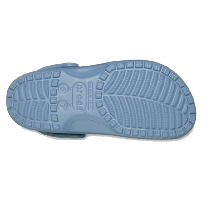 The image displays the bottom view of the Crocs Classic Clog Astro Blue Adults Unisex, highlighting its textured rubber sole with tread patterns designed for grip., 53294, 198445438936, 198445438943, 198445438950, 198445438967, 198445438974, 198445438820, 53301, 53302