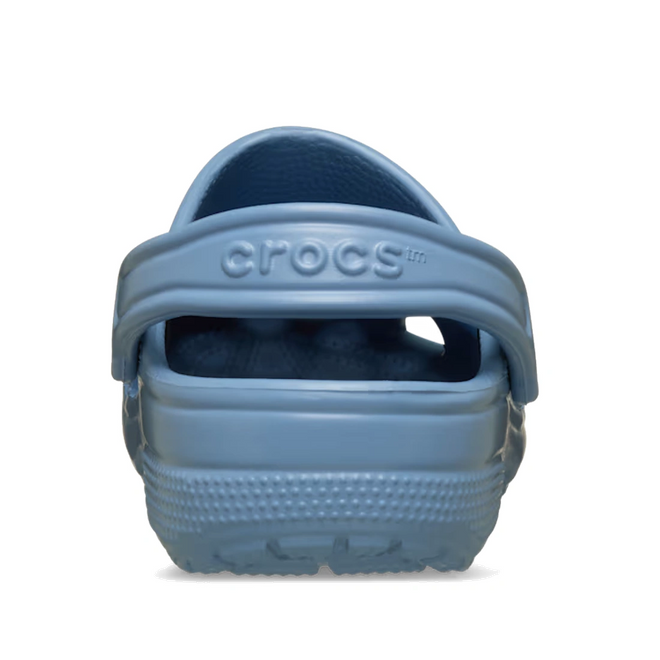 A rear view of a single Crocs Classic Clog Astro Blue Adults Unisex shoe with the heel strap raised, displaying the Crocs logo on the strap., 53294, 198445438936, 198445438943, 198445438950, 198445438967, 198445438974, 198445438820, 53301, 53302