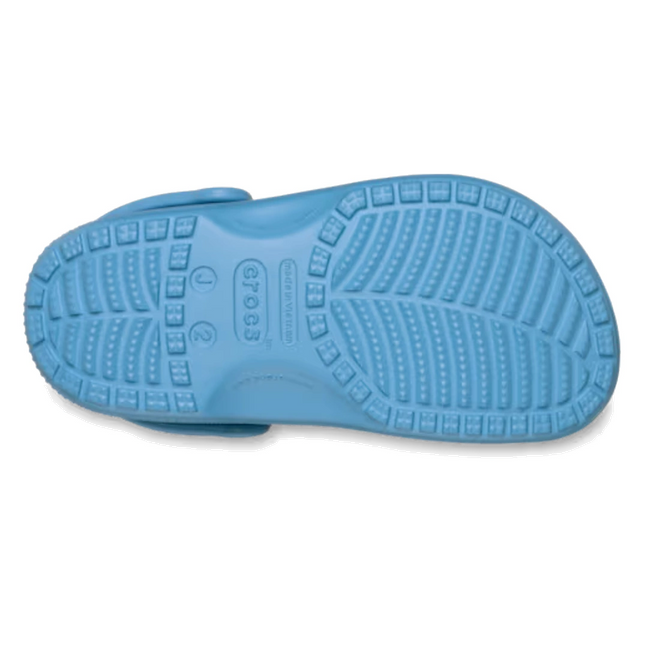 The image displays the sole of a Crocs Kids - Classic Clog Elite Blue (Junior Youths Sizes) shoe, featuring textured treads and an embossed Crocs logo in the center. These water-friendly clogs are designed for comfort and easy wear., 198445398209, 198445398216, 198445398223, 198445398230, 198445398247, 198445398254, 198445398261, 53310, 53311