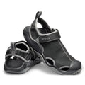 A pair of Crocs - Mens Swiftwater Mesh Deck LiteRide Sandals in black, featuring gray accents, mesh uppers, and adjustable straps. One sandal stands upright while the other is tilted to show the water-friendly sole and heel.