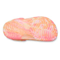The image displays the sole of the Crocs Kids - Marbled Clog Sandal Guava Pink Multi Youths, featuring pink and orange marbling. Its tread includes ridges and circular indentations for grip, inspired by the classic Crocs clog design., 198445354540, 198445354557, 198445354564, 198445354571, 198445354588, 198445354595, 198445354601, 49886, 49887