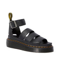 Dr Martens Clarissa II Quad Platform Sandal in black, featuring three thick straps, an adjustable buckled ankle strap, and yellow stitching around the milled Nappa leather sole.