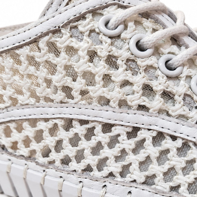 Close-up of Django & Juliete Hamburger White Syn Raffia Leather Sneakers featuring a woven, net-like pattern, white laces, and detailed stitching.