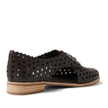 The Django & Juliette Adalina Leather Women’s Cut Out Brogues in Chocolate Brown feature laser-cut scalloped edges, a low stacked heel, and stylish side cutouts. These breathable summer shoes are displayed from a back side angle against a white background.