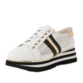The Django & Juliette Eminta Platform Shoe is a white women’s lace-up sneaker featuring gold eyelets, black and gold side stripes, sheer leather side panels, and a bold black-and-white striped platform sole.