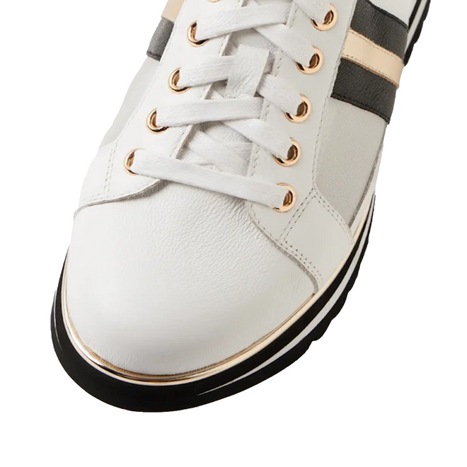 A close-up of the Django & Juliette Eminta Platform Shoe features sheer leather panels, gold eyelets, black and gold side stripes, white laces, and a black-and-white sole.