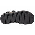The image shows the black rubber sole of the Django & Juliette Inbar Womens Black Sandal w/Back Strap, featuring deep horizontal grooves and a subtle triangular patterned texture in the center.