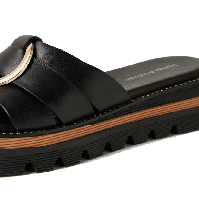 A close-up of the Django & Juliette Scoop Platform Slide Black—a stylish women’s leather slide featuring a thick, ridged black platform sole, tan stripe detail, and a gold accent on the upper strap.
