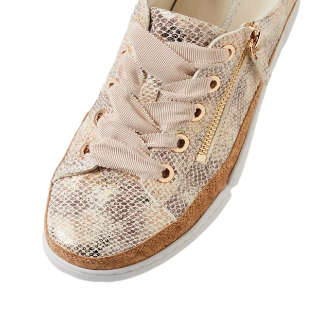 A close-up of the Django & Juliette Torayne Women’s Ombre Beige Sneakers showcases their beige snakeskin-patterned leather, beige laces, gold eyelets, and a gold zipper detail on the side. These stylish sneakers feature a white sole with a brown trim above it, making them perfect for casual wear.